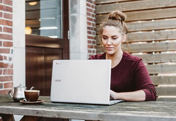 woman at laptop outside by anete lusina on unsplash